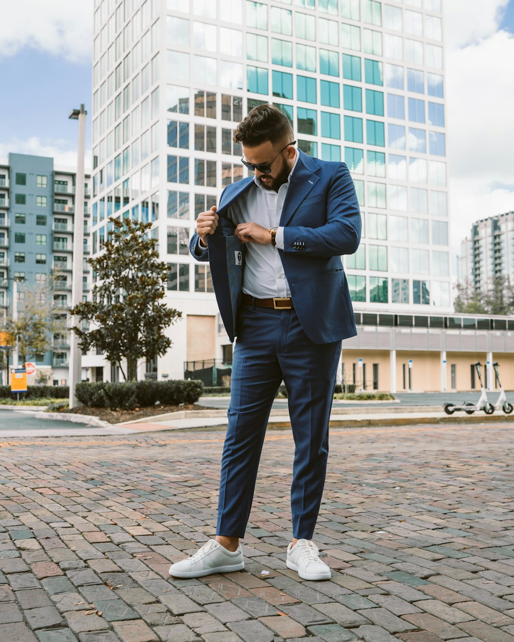 A man in a blue suit and white shoes photo – Free Suit Image on Unsplash
