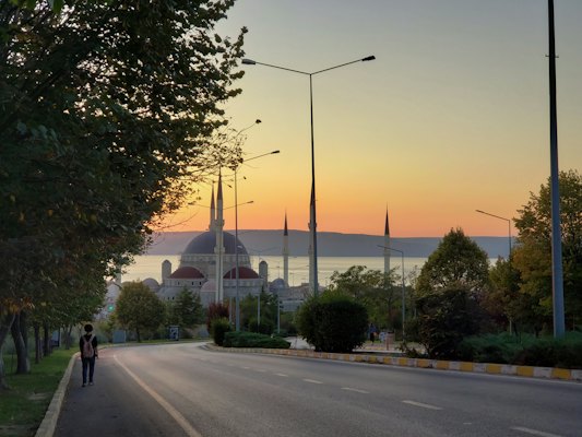A couple of people walking down a street — Çanakkale, Turkey