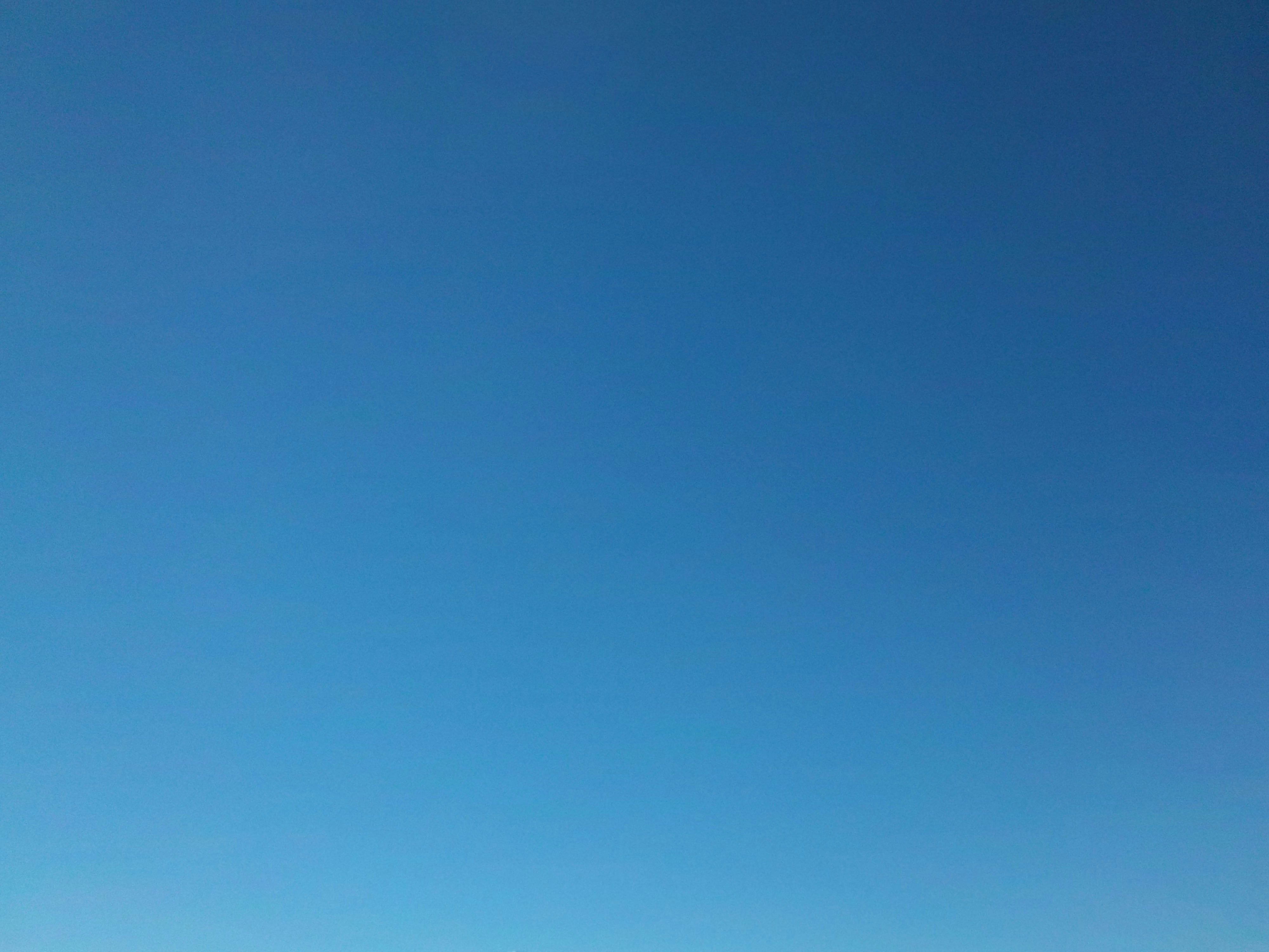 a group of people standing on top of a sandy beach