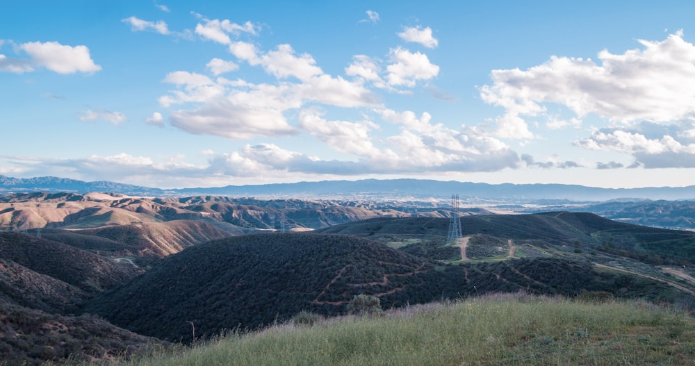 a scenic view of a valley with mountains in the background