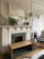 A beautifully decorated living room featuring a stylish fireplace with an elegant statue on the mantel.