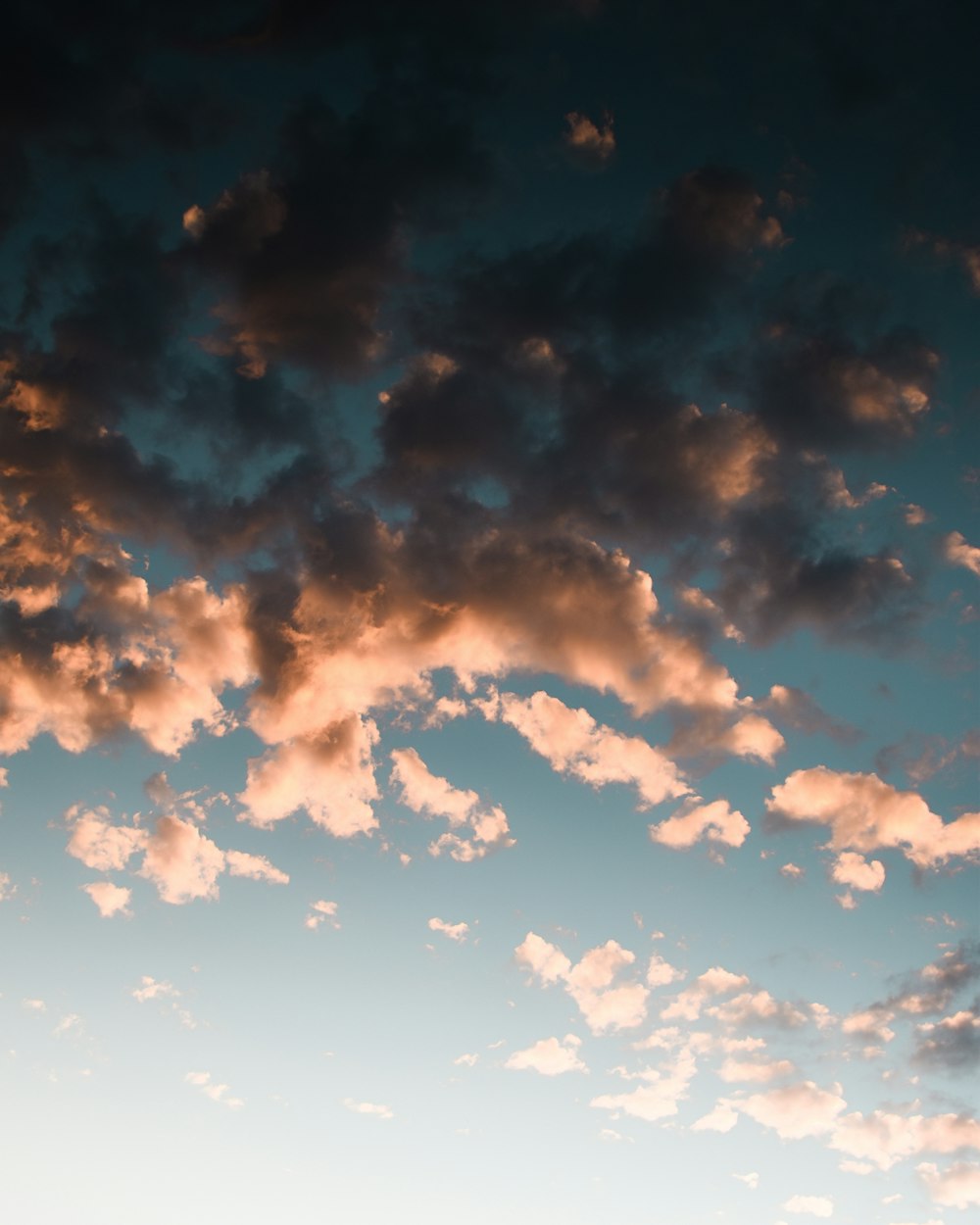 a plane flying in the sky with a lot of clouds