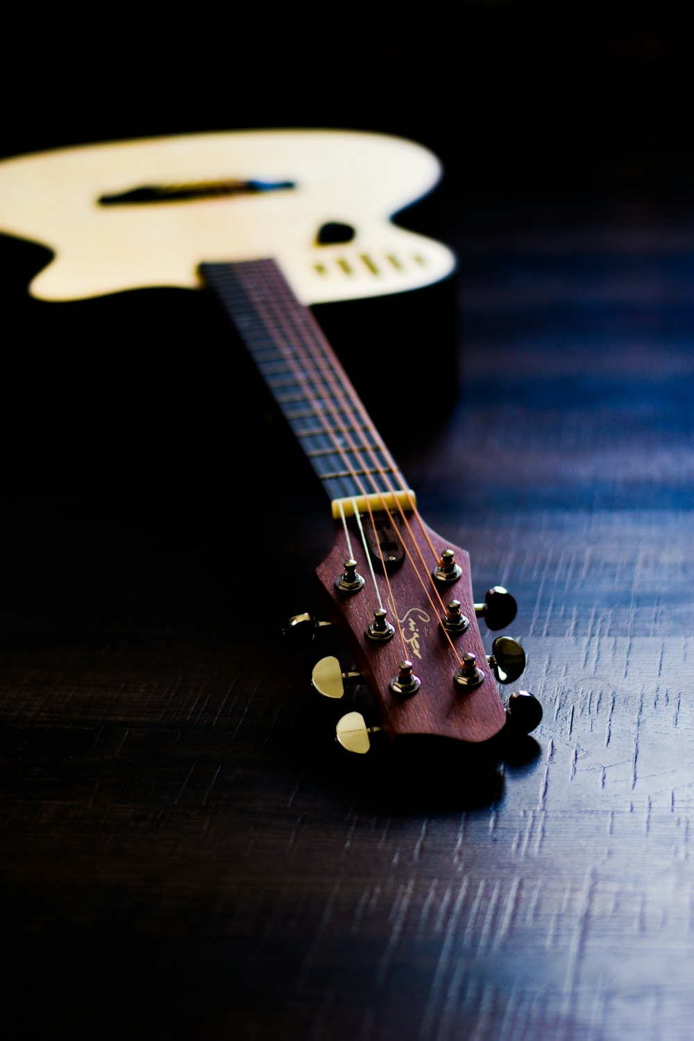 a close up of a guitar on a table