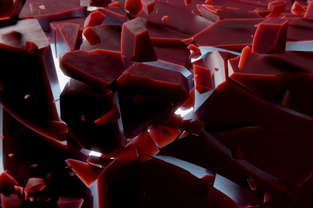 a bunch of red pieces of glass on a table