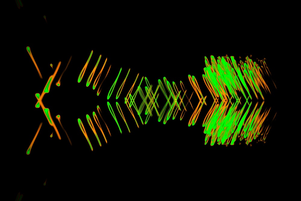 a black background with green and orange lines