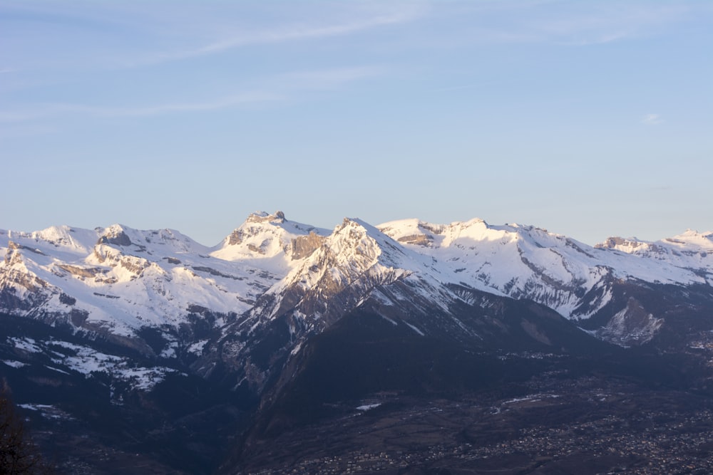 a mountain range with snow covered mountains in the background