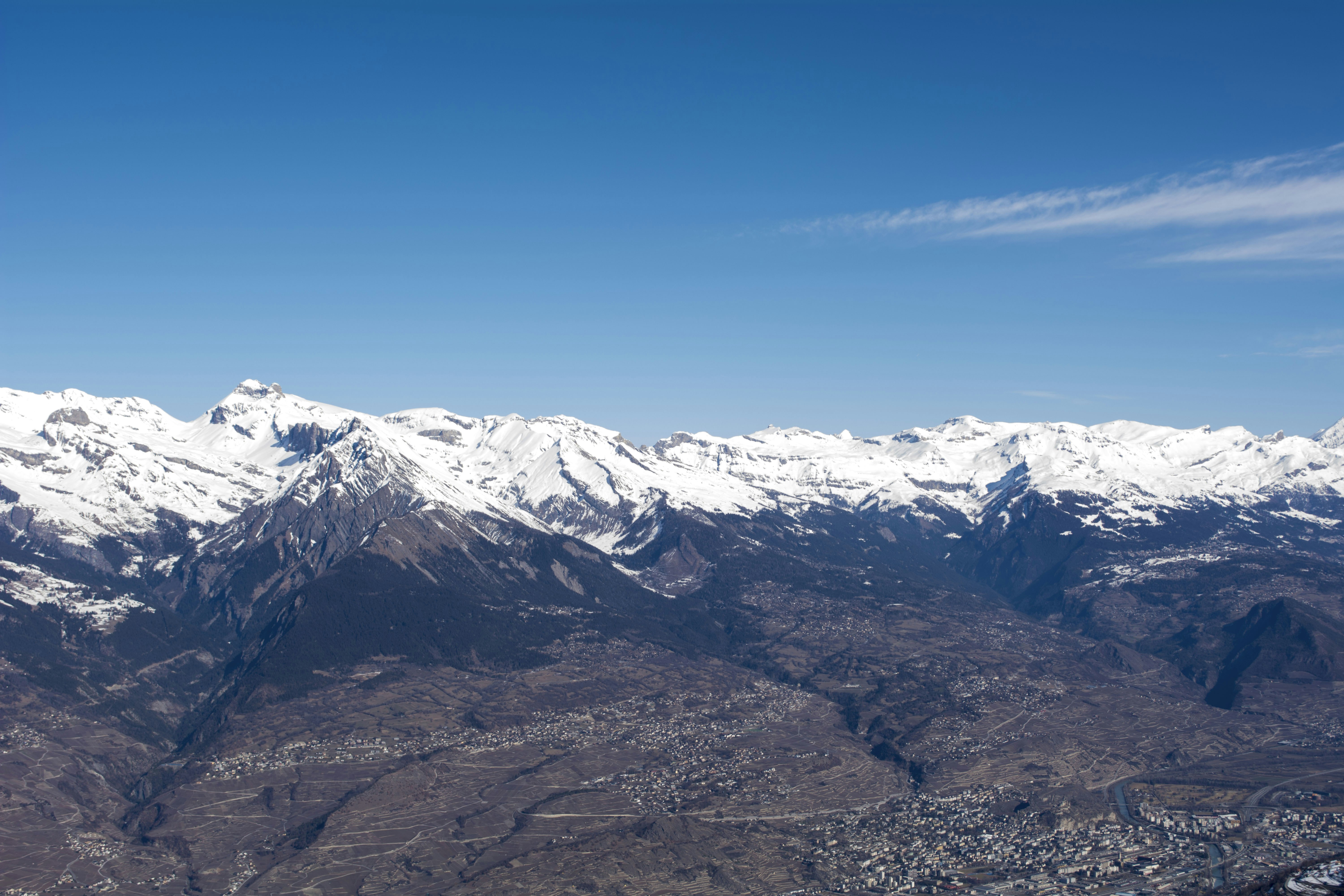 a view of a snowy mountain range from an airplane