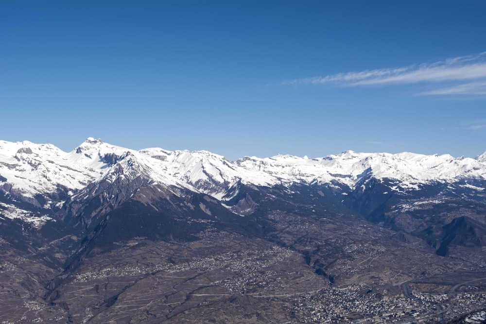 a view of a snowy mountain range from an airplane