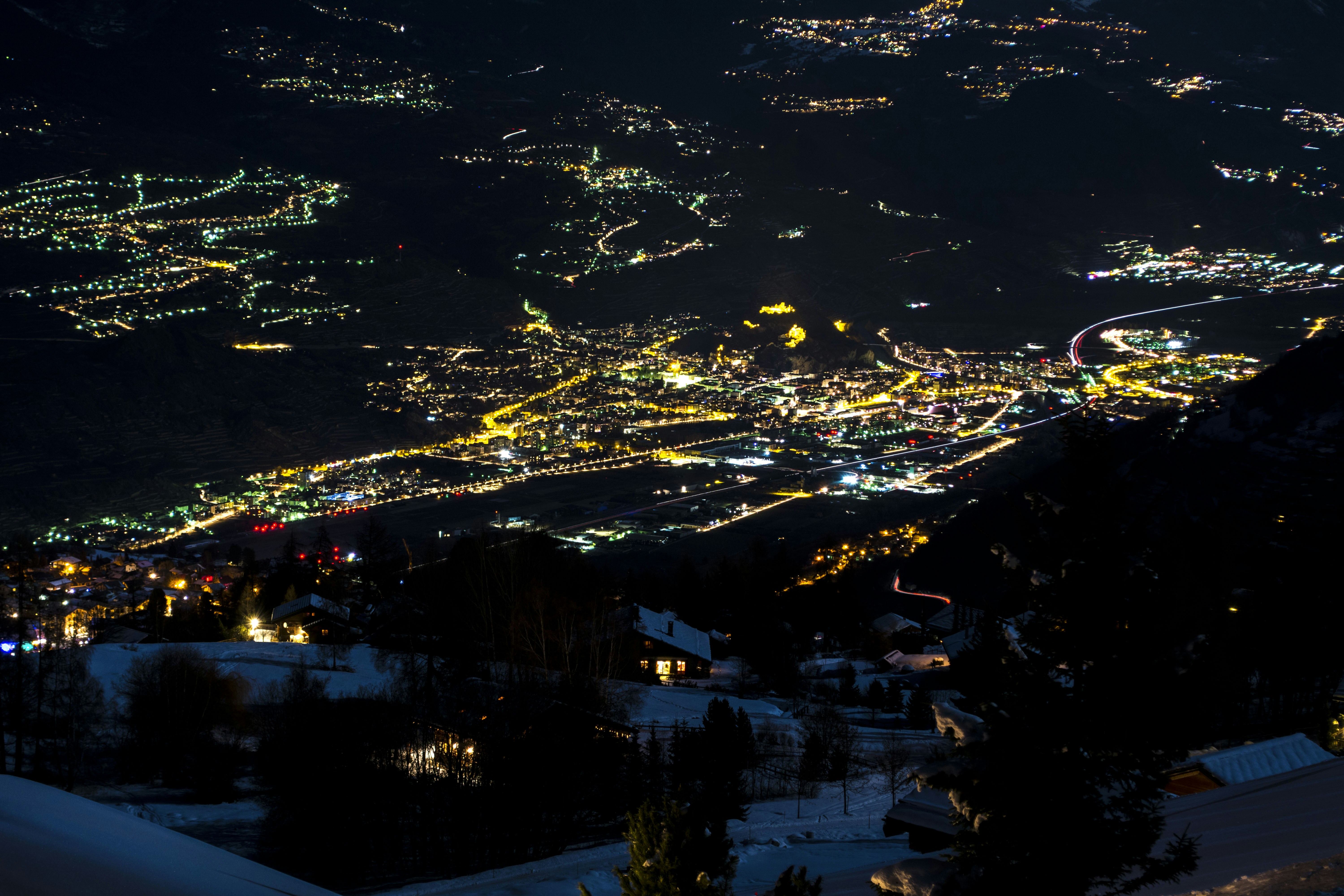 a night time view of a city lit up with lights