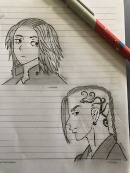 A sketch on lined notebook paper depicts two distinct anime-style characters. The top character has medium-length hair and a serious expression, wearing a collared jacket. The bottom character has a unique hairstyle with braids and intricate side patterns, showcasing a fierce expression.
