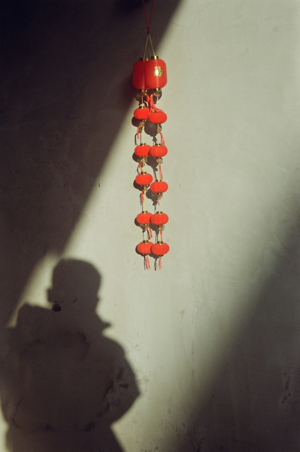 a shadow of a person standing next to a wall