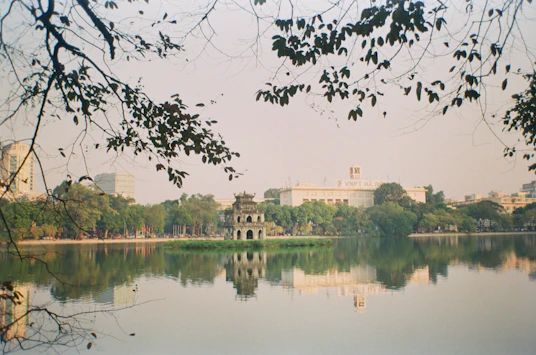 a body of water surrounded by trees and buildings