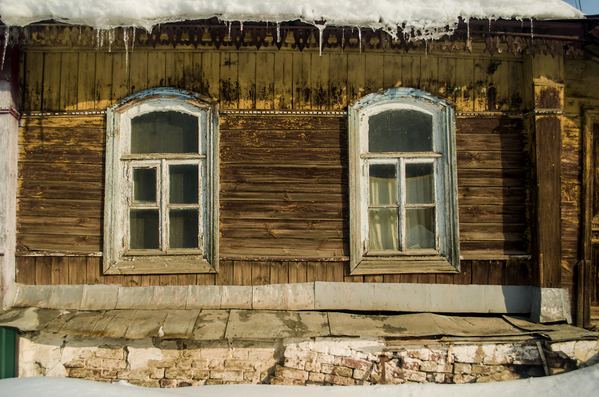 Weathered timber windows before replacement