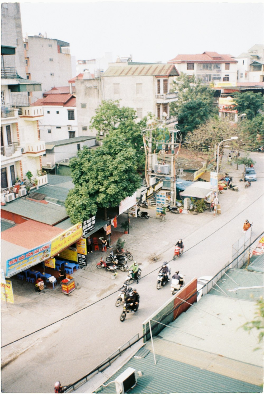 a group of people riding motorcycles down a street