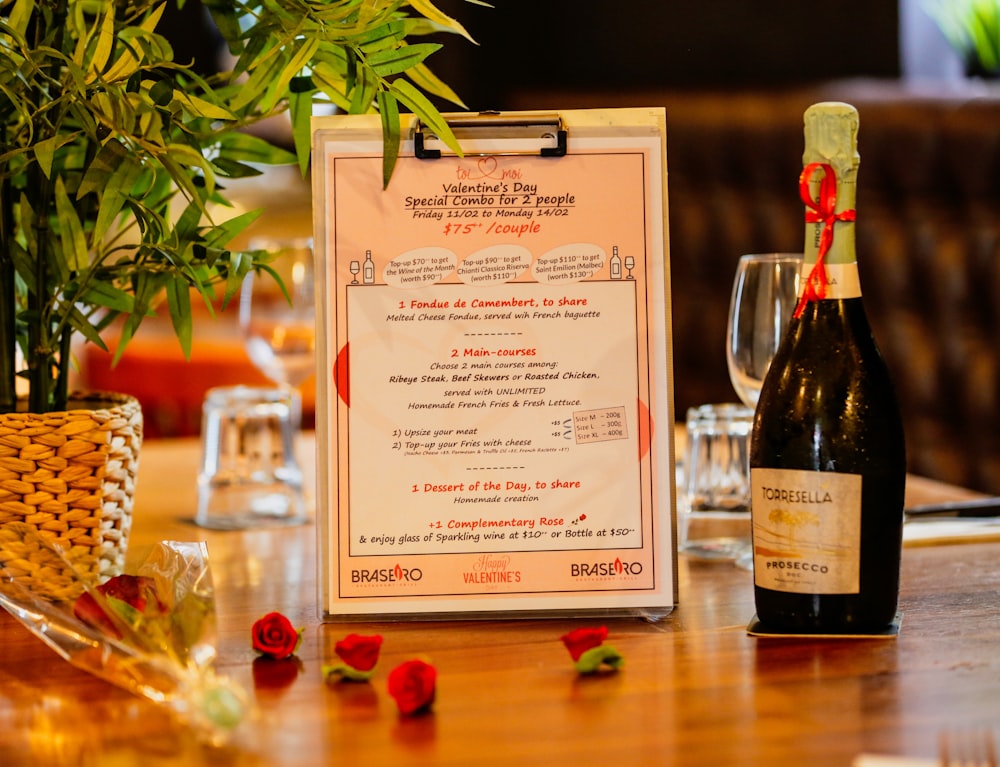 a menu and a bottle of wine on a table