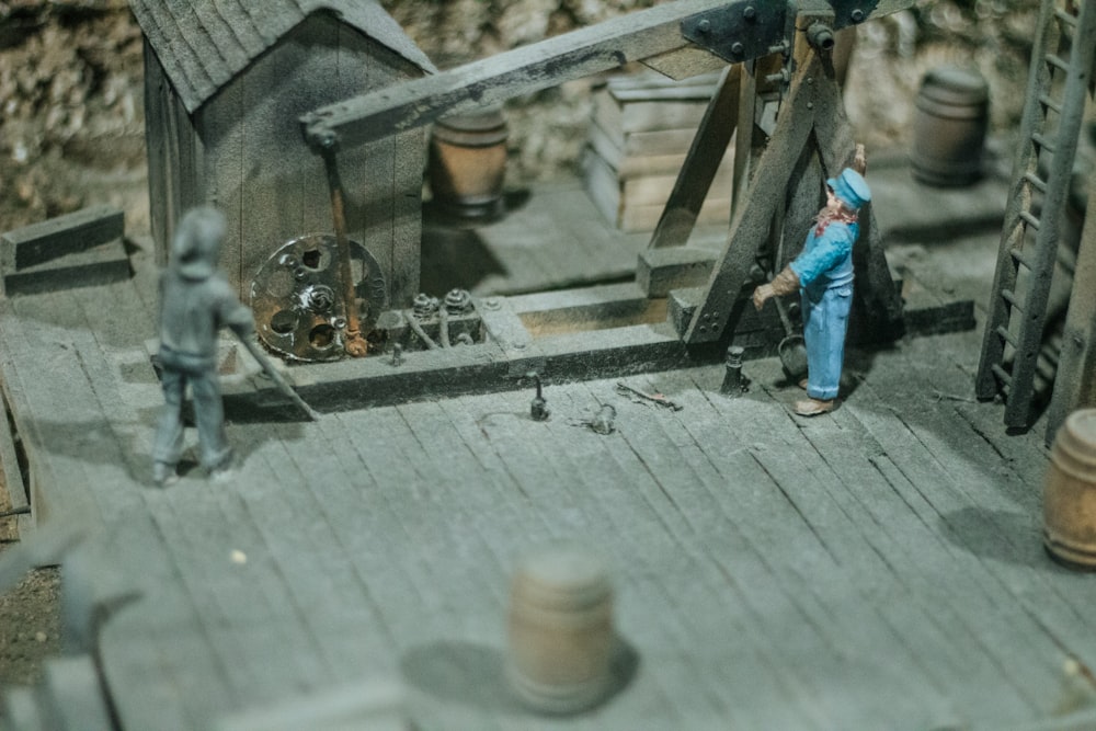 a toy figurine of a man working on a house