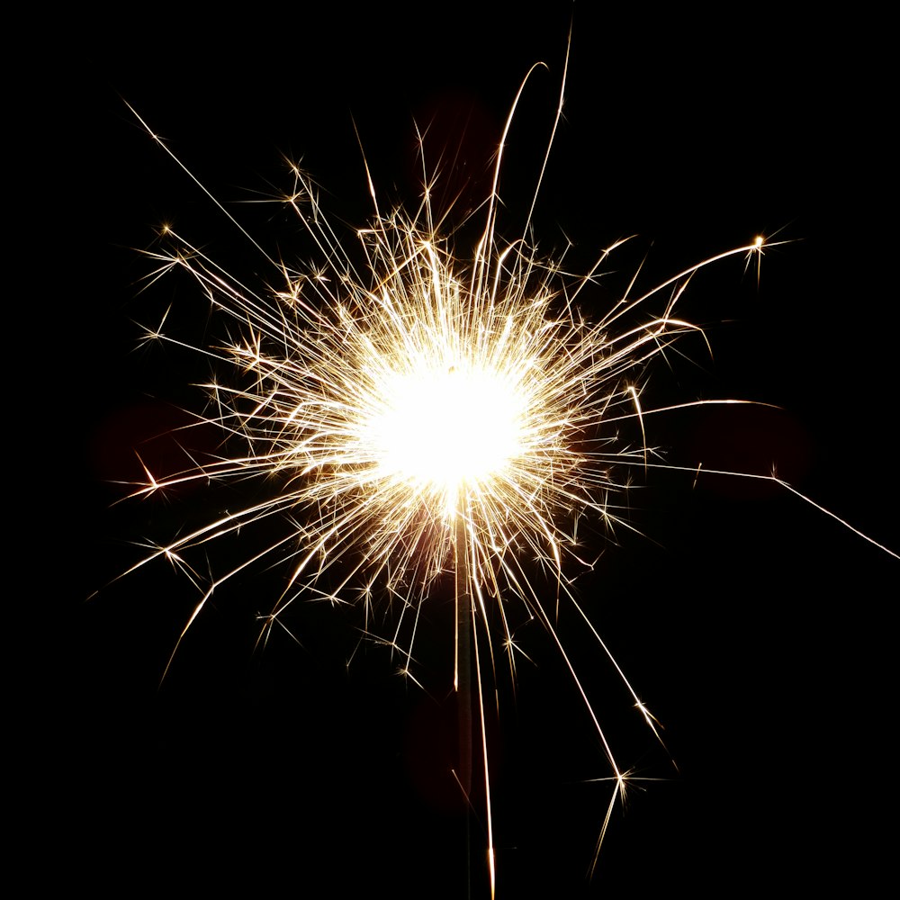 a close up of a sparkler on a black background