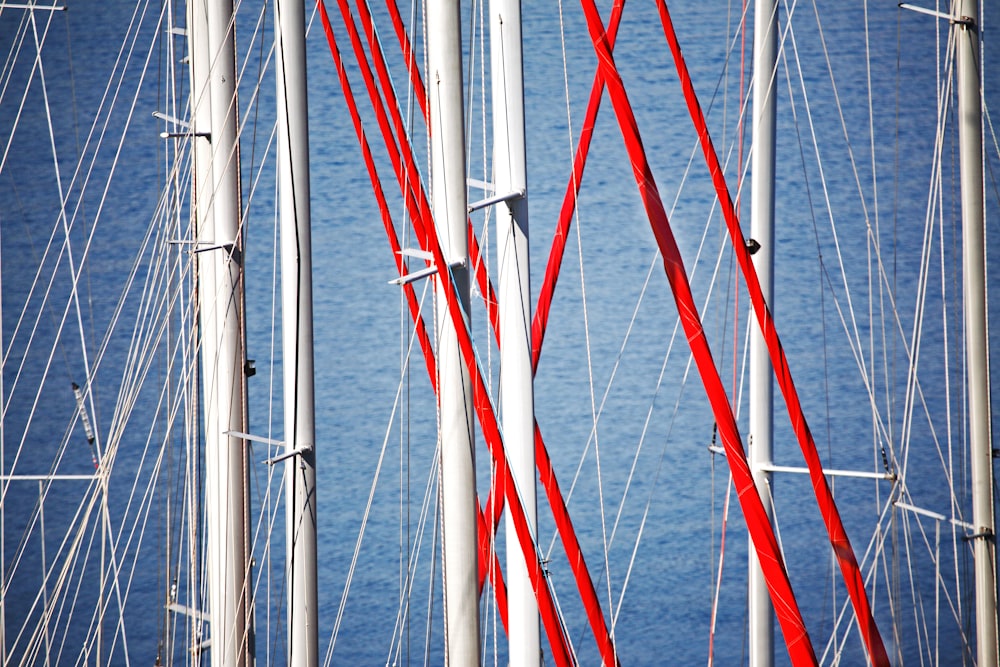 the masts of a sailboat are red and white