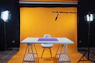 a photo studio with a table and chairs
