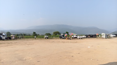 A spacious outdoor parking area filled with caravans and motorhomes under a clear sky.