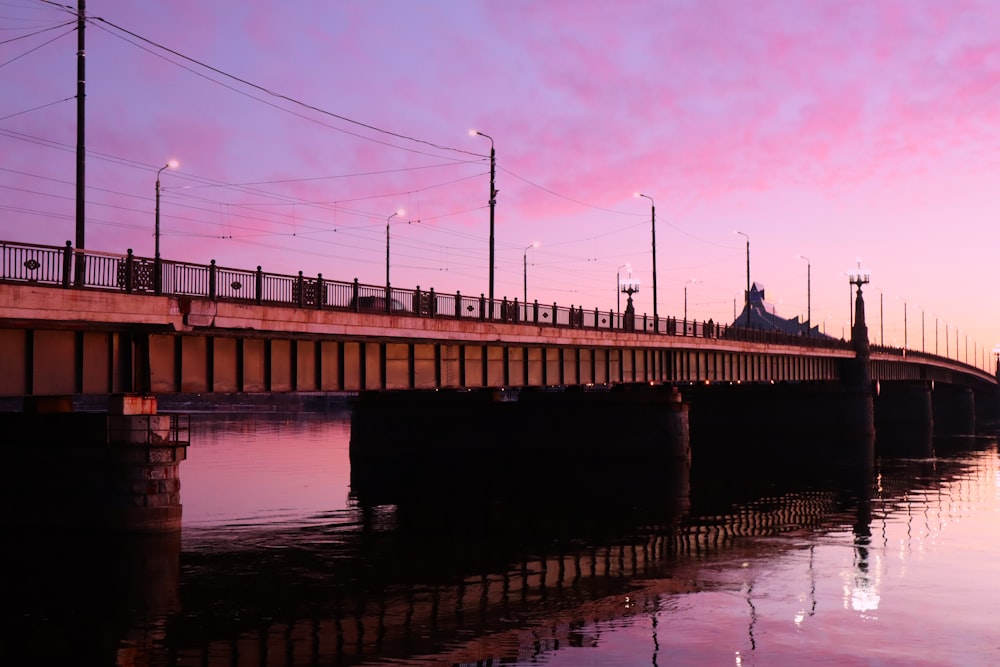 a bridge over a body of water at sunset