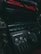 Close-up of a vintage audio system with red digital text displaying '2000W PMPO' and 'Video CD'. Various buttons and dials are visible, including controls labeled 'A' and 'B'. The lighting is dim, accentuating the retro aesthetics of the device.