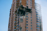 Photo of a building expert inspecting structural damage on a Parisian apartment facade.