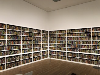 A group of diverse people sorting and packing donated books in a bright room.