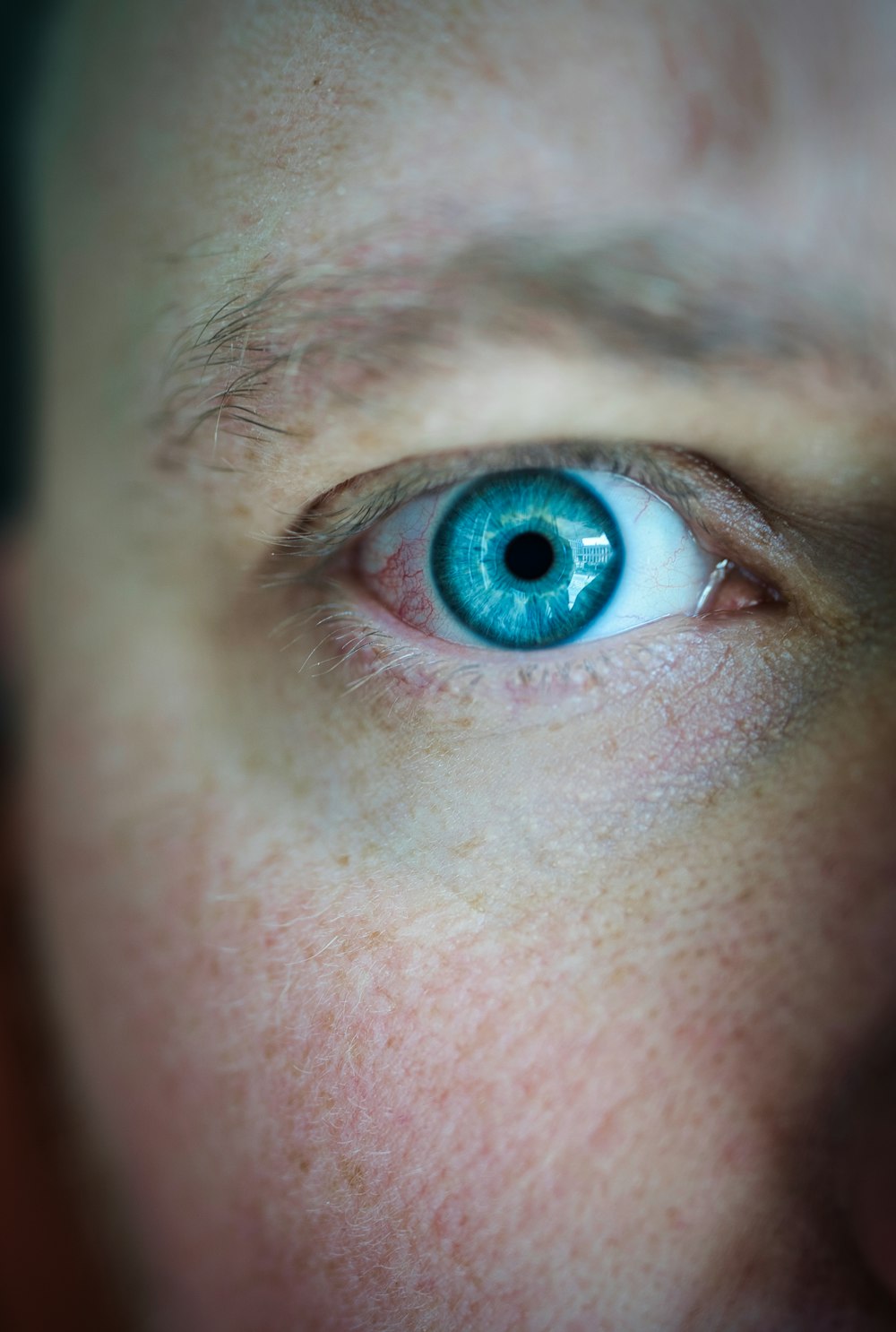 a close up of a person with a blue eye