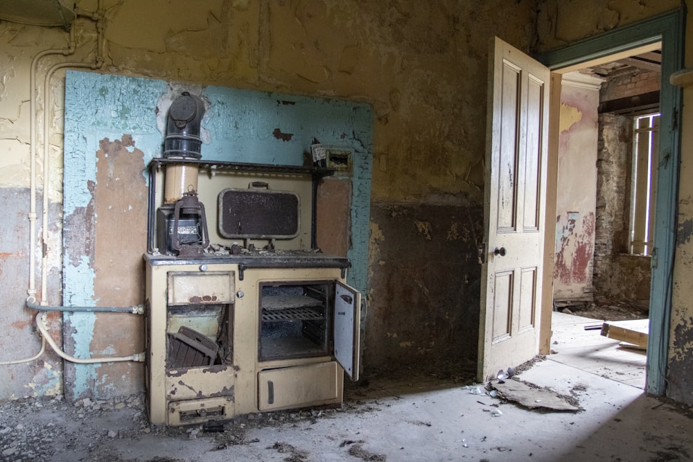an old stove and oven in a run down room