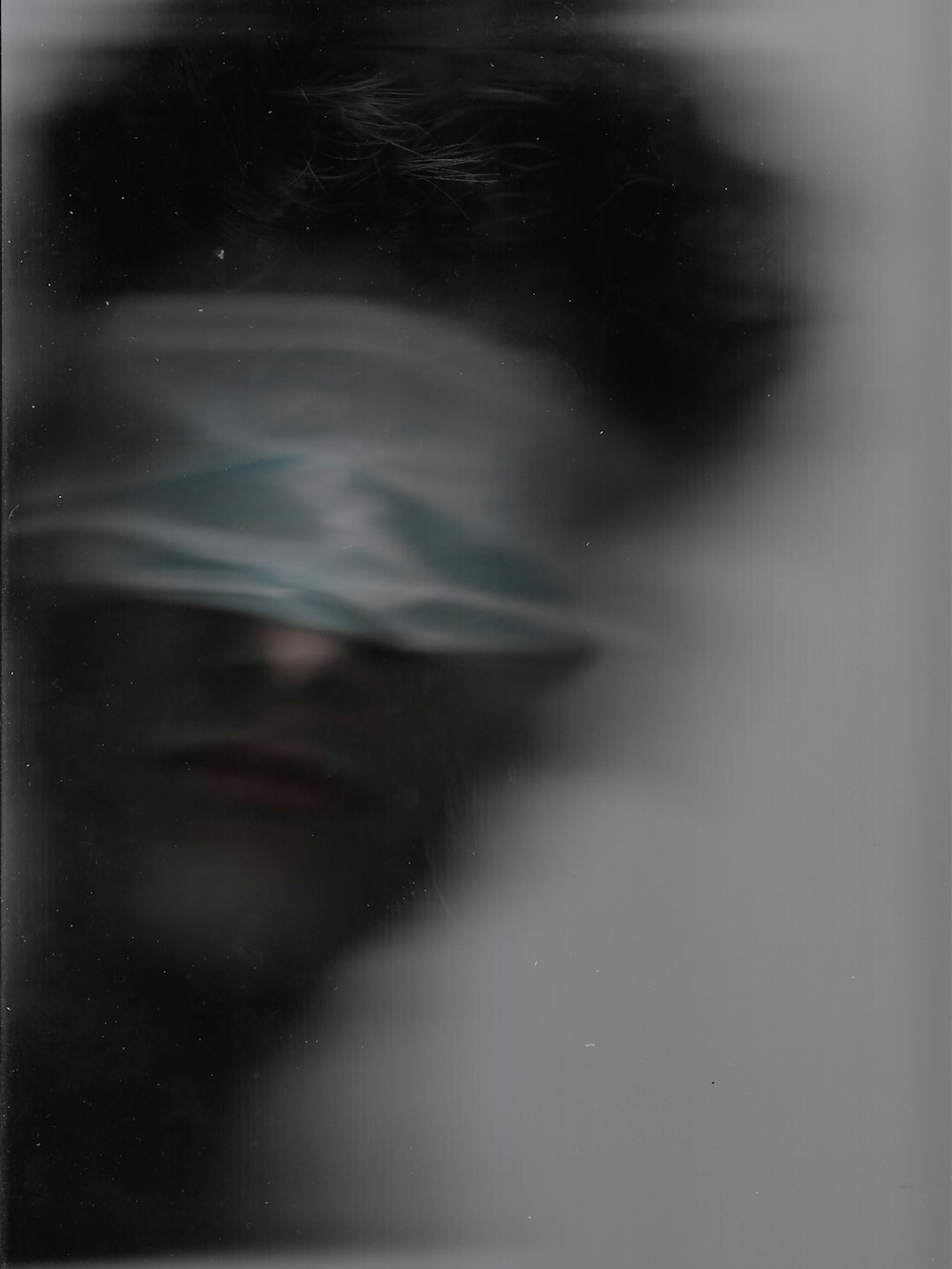 a blurry photo of a person with a blindfold