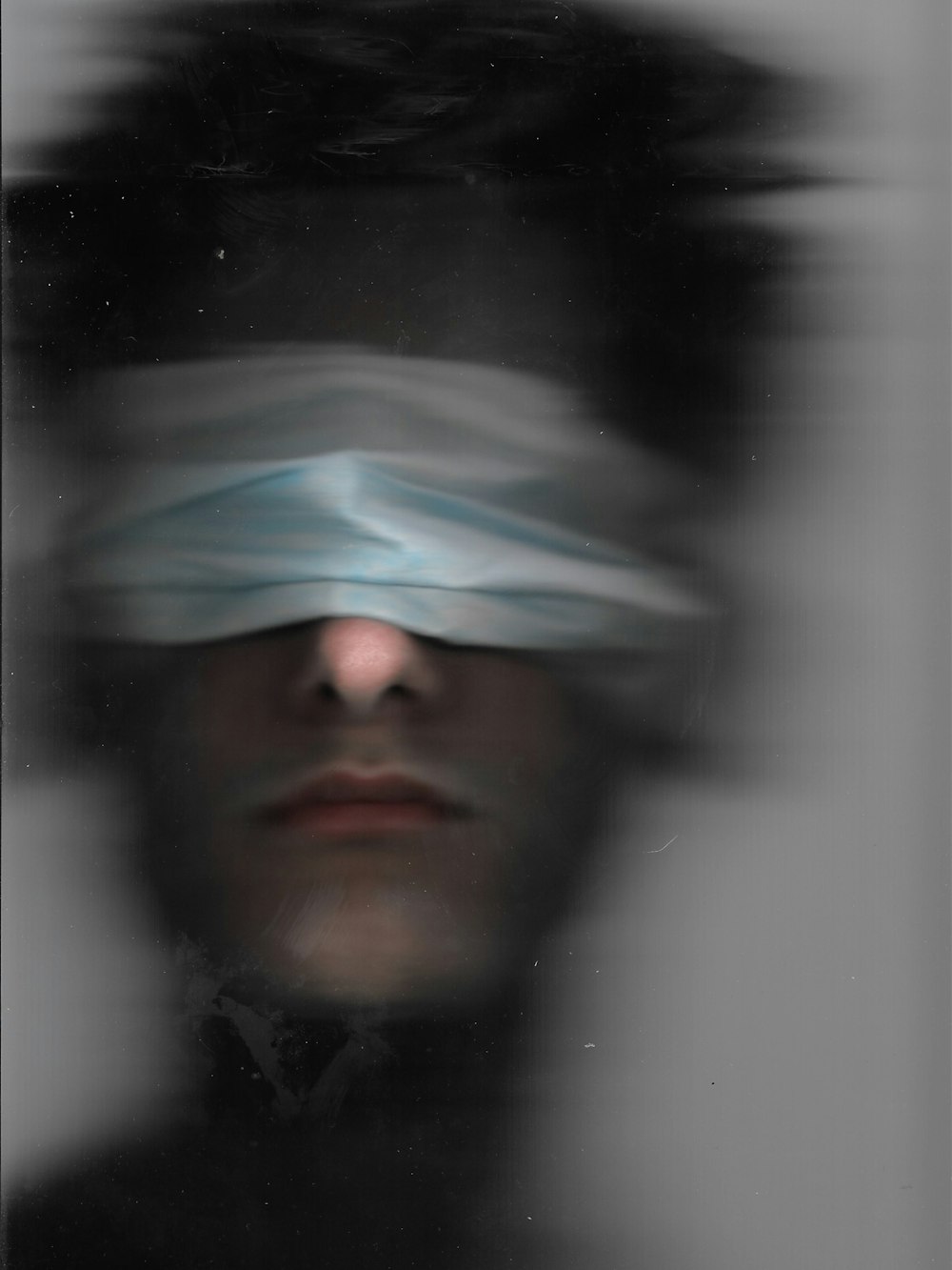 a man with a blindfold over his eyes