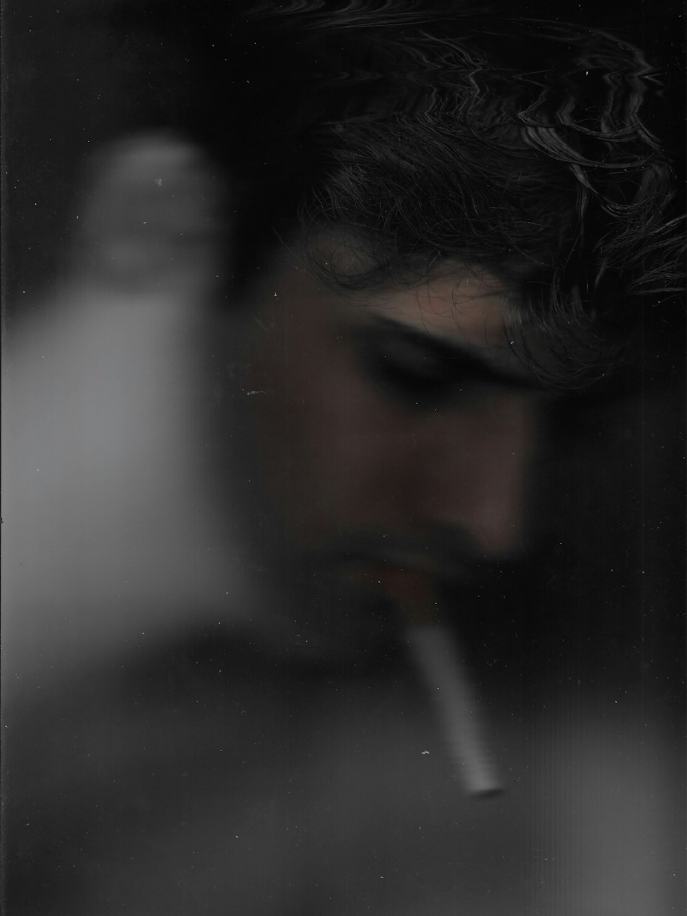 a man with a cigarette in his mouth