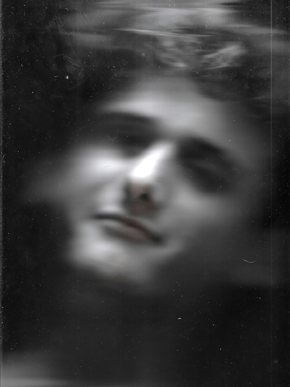 a blurry photo of a man's face in black and white