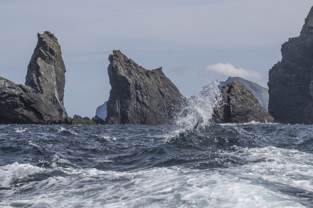 a group of rocks sticking out of the ocean