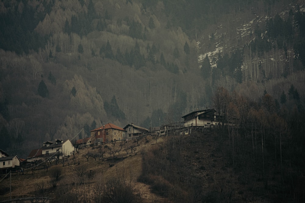 a village on a hill surrounded by mountains