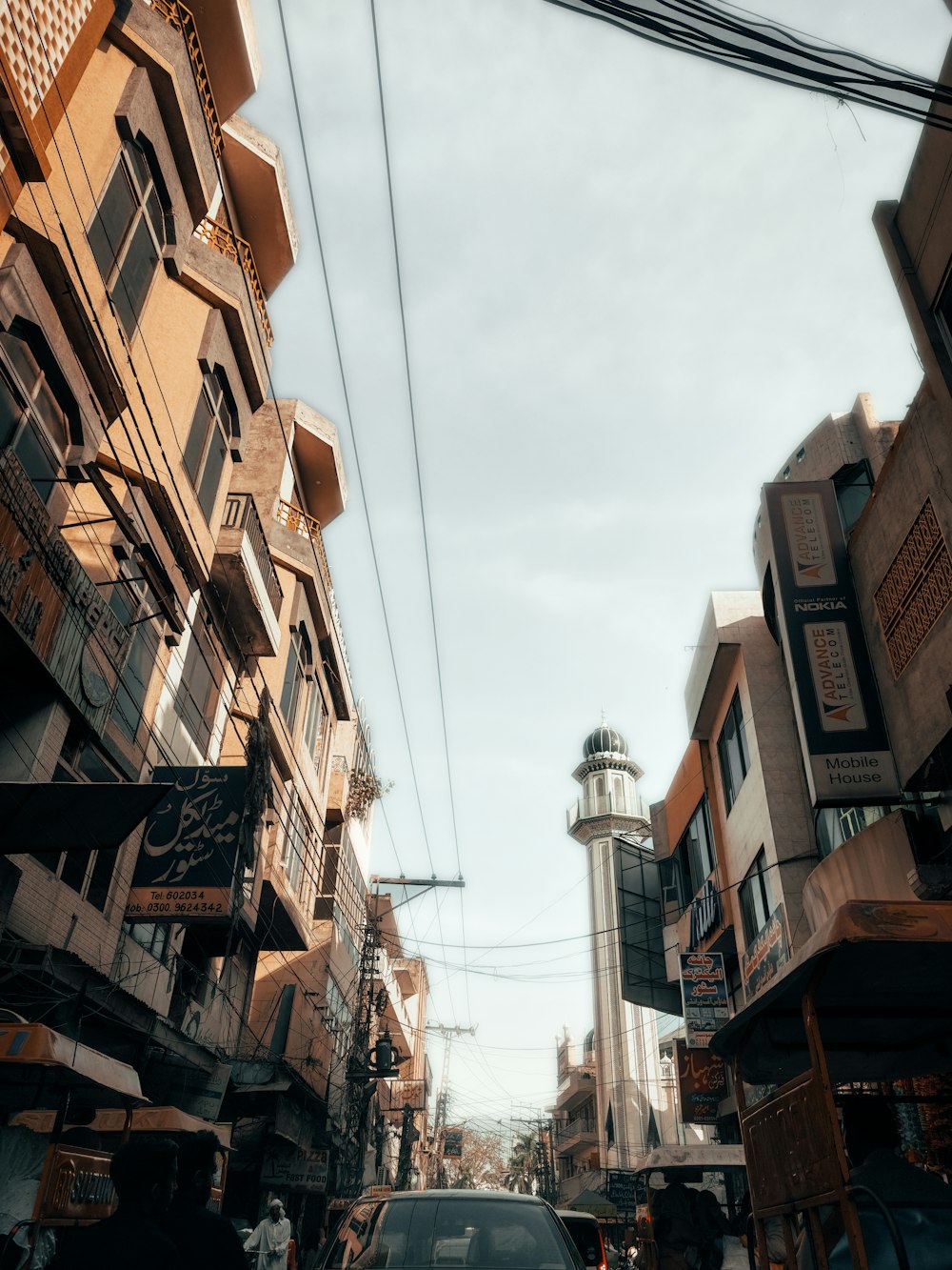 a car driving down a street next to tall buildings