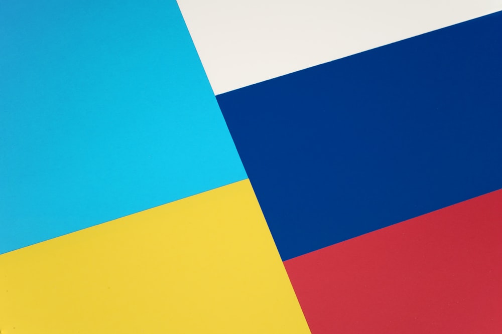 a close up of a blue, yellow, and red background