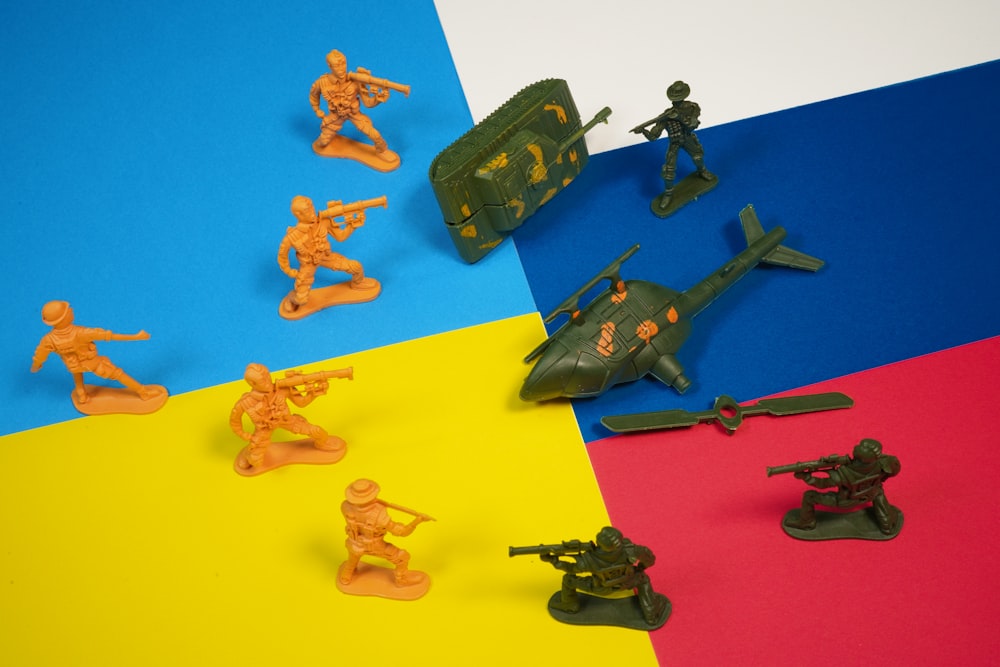 a group of toy army figures on a multi - colored background