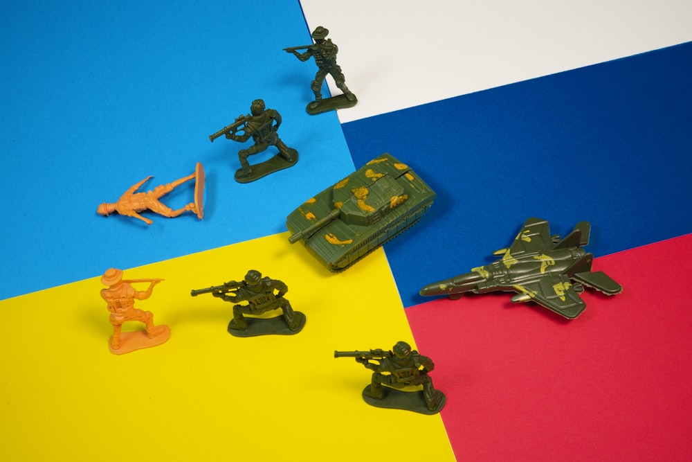 a group of toy army figures on a multicolored background
