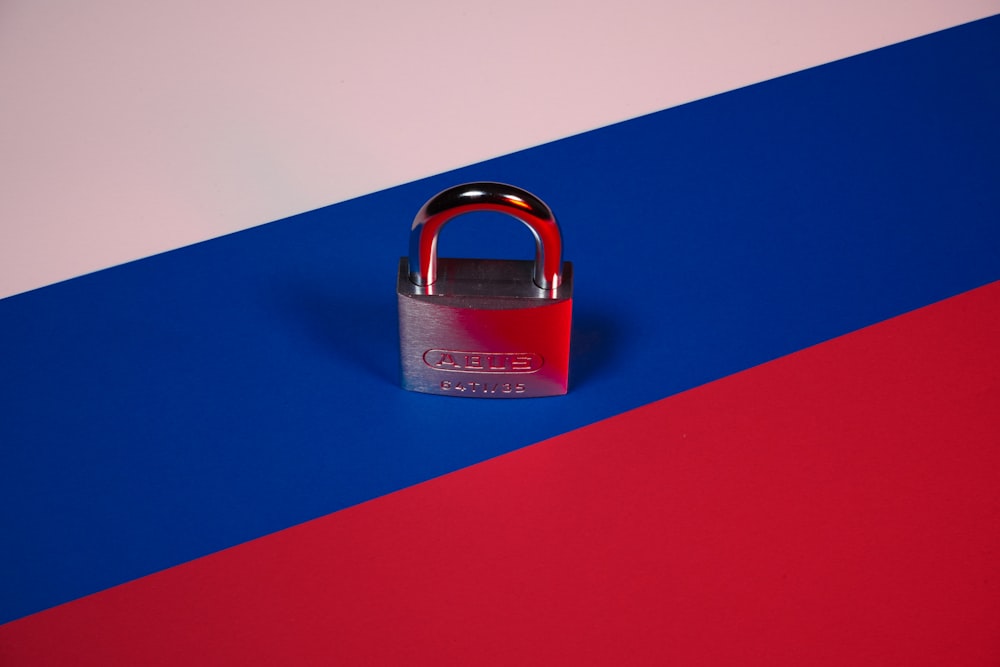 a padlock on a red, blue, and pink background