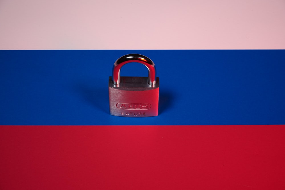 a red, white and blue background with a padlock