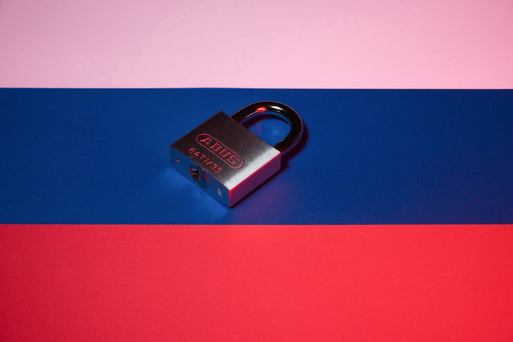 a padlock on a red, blue, and pink background