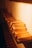 A row of neatly arranged gold bars on a shelf, illuminated by warm lighting, creating a luxurious and rich ambiance.