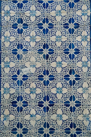 a blue and white tile with a design on it