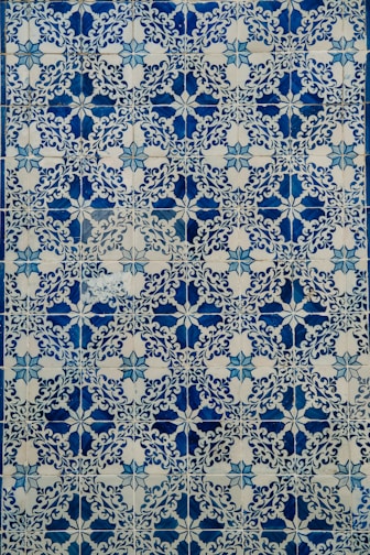 a blue and white tile with a design on it