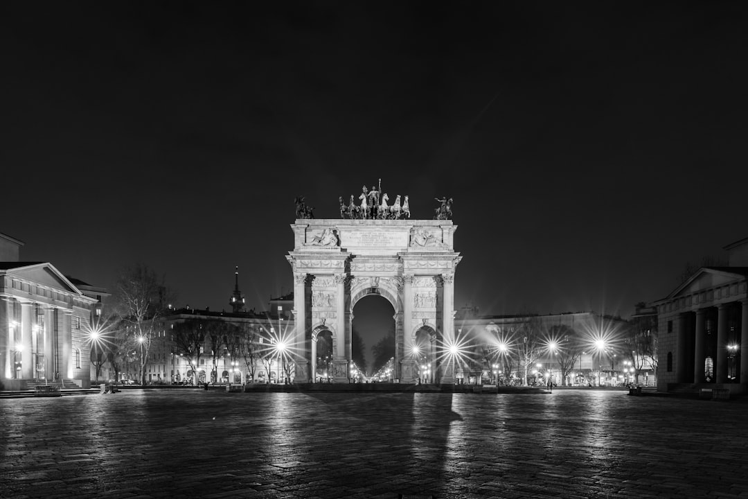 a black and white photo of a city at night,