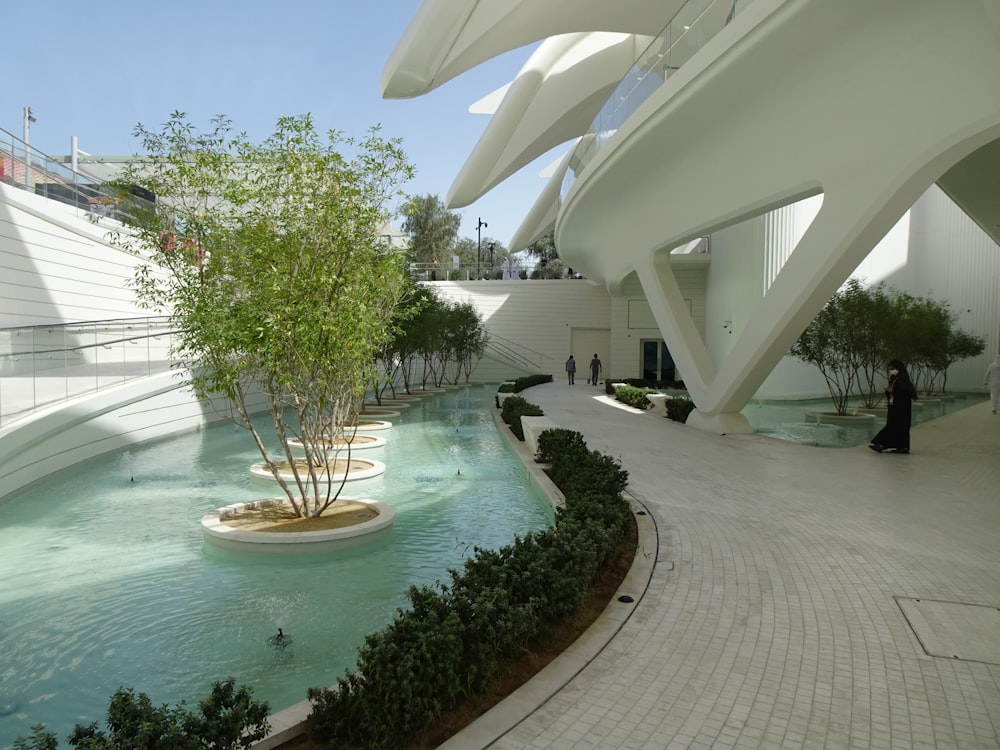 a courtyard with a fountain and trees in the center