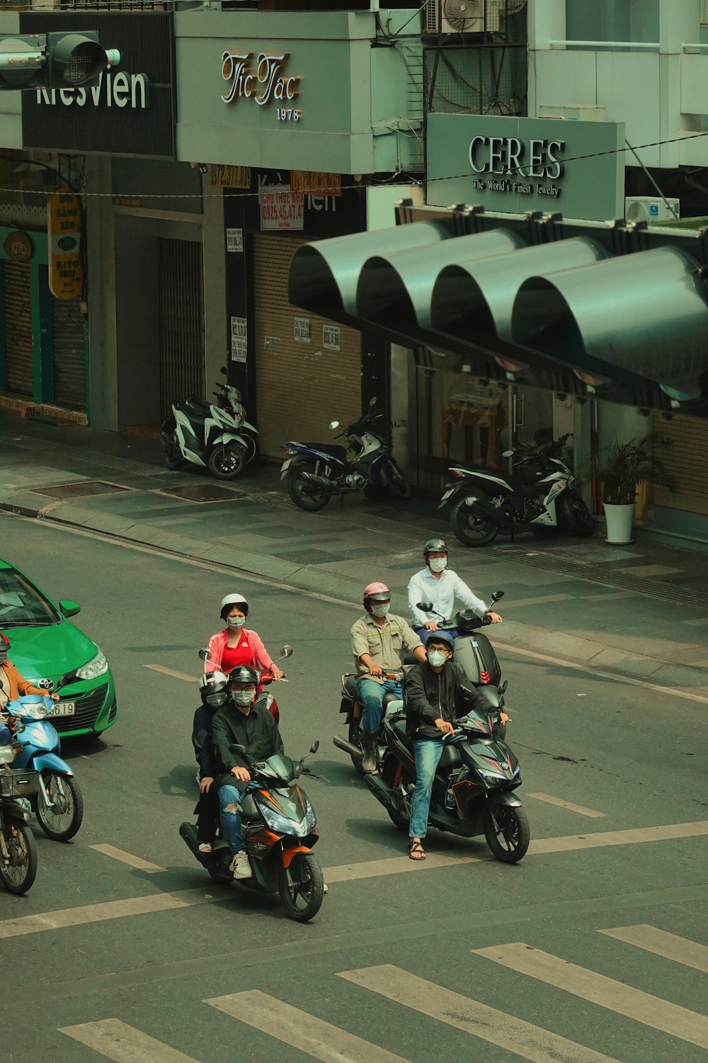 a group of people riding motorcycles down a street