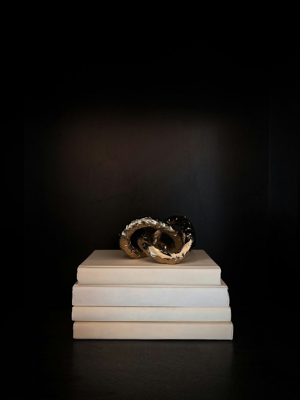 a stack of white books with a black background
